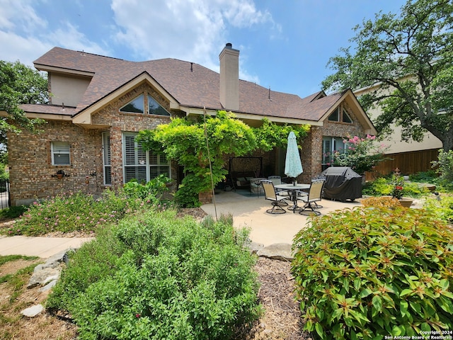 rear view of property featuring a patio