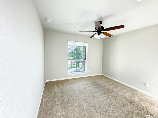 spare room featuring carpet flooring and ceiling fan