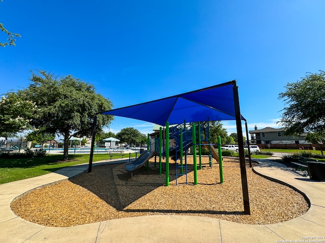 view of jungle gym with a pool