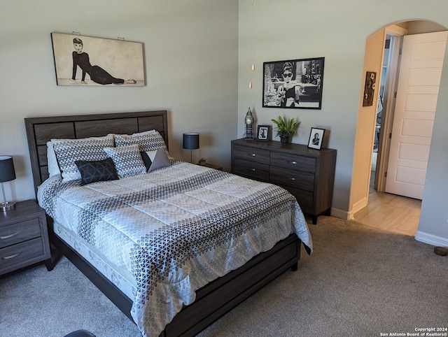 bedroom featuring light colored carpet