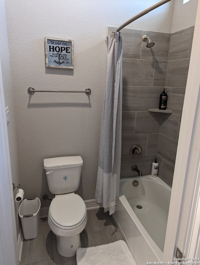 bathroom with toilet and shower / tub combo