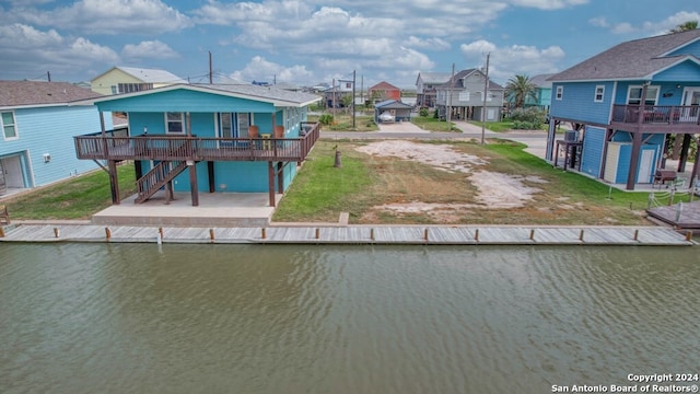 rear view of property featuring a deck with water view