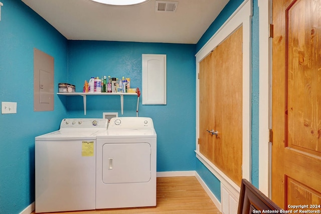 laundry room featuring separate washer and dryer, hookup for a washing machine, and light wood-type flooring