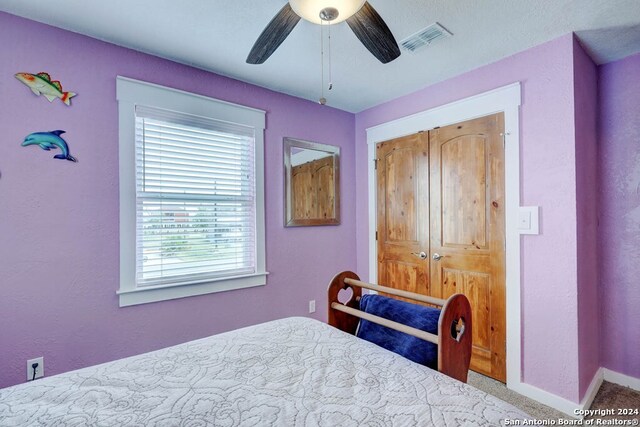 bedroom featuring carpet, a closet, and ceiling fan