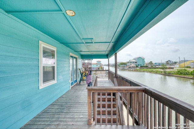 wooden terrace featuring a water view