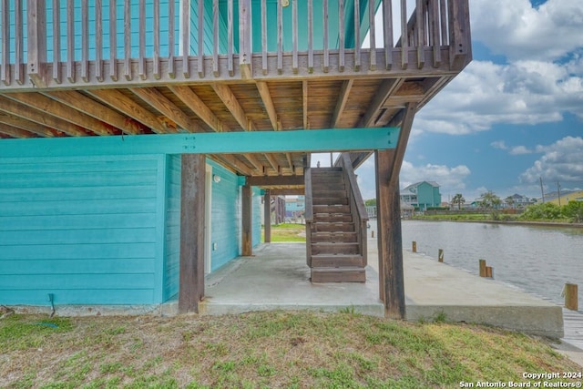 exterior space with a deck with water view and a patio area