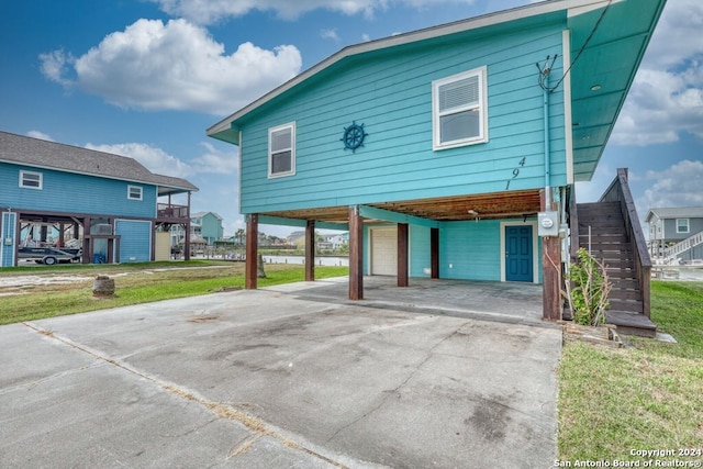 rear view of property featuring a garage