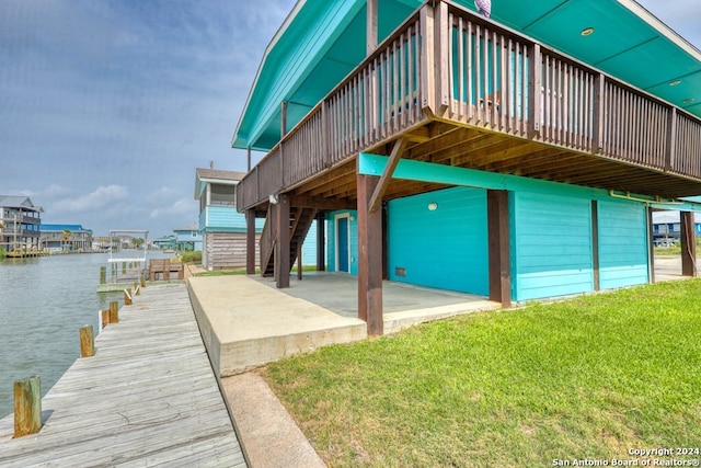 dock area featuring a water view and a yard