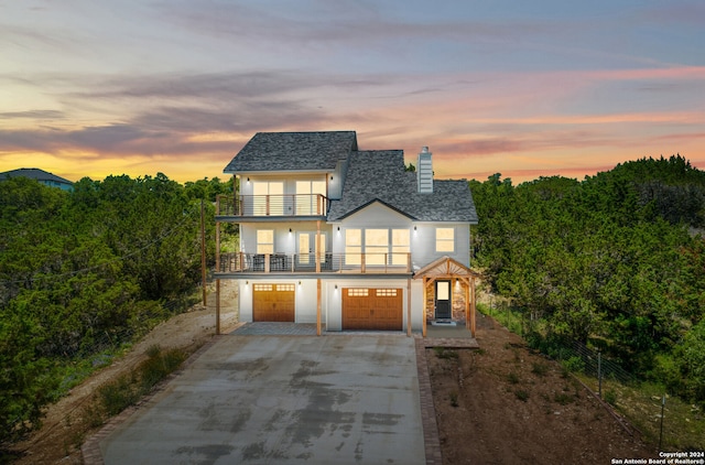 view of front of home featuring a garage and a balcony