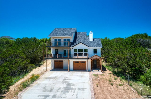 view of front of home with a garage and a balcony