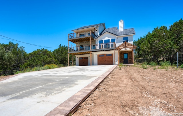 view of front of house with a garage and a balcony