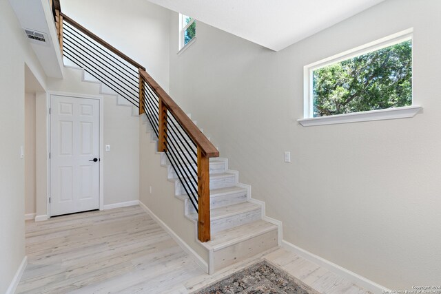 staircase featuring light wood-type flooring