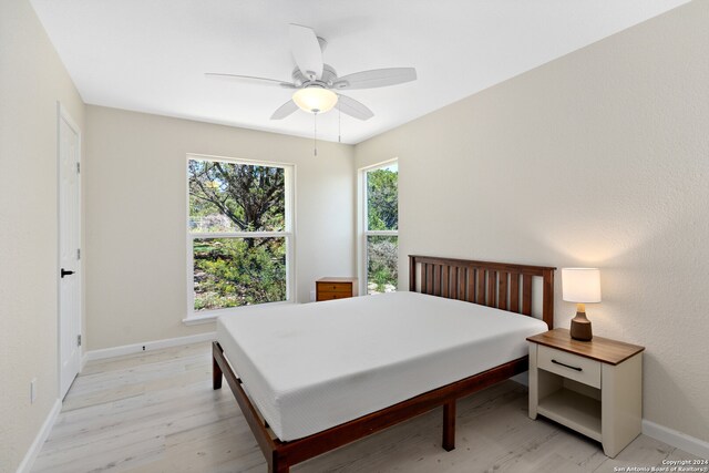 bedroom with ceiling fan and light hardwood / wood-style flooring