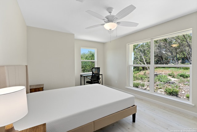 bedroom with ceiling fan and hardwood / wood-style floors