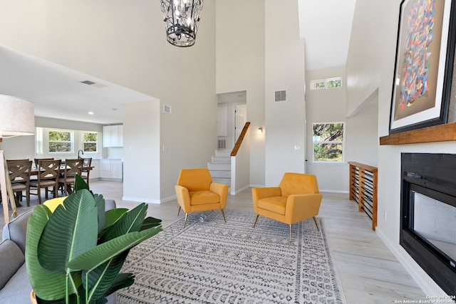 living room featuring light hardwood / wood-style floors and a chandelier