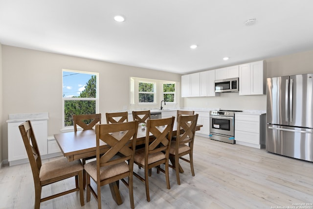 dining area with a healthy amount of sunlight and light wood-type flooring