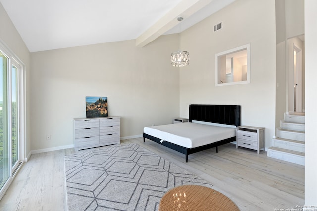 bedroom with high vaulted ceiling, multiple windows, hardwood / wood-style floors, and a notable chandelier