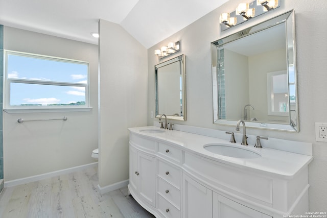 bathroom with dual vanity, hardwood / wood-style flooring, and toilet