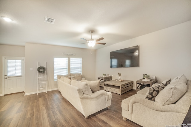 living room featuring hardwood / wood-style floors and ceiling fan