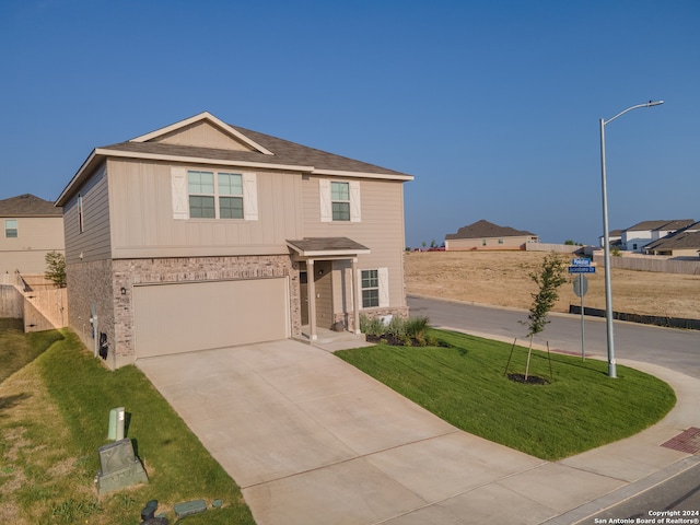 view of front of house featuring a front yard and a garage