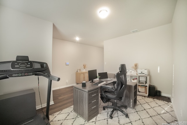 home office with light hardwood / wood-style flooring