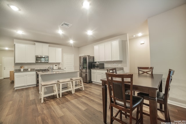 dining space with dark wood-type flooring