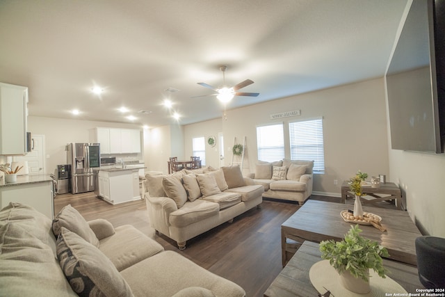 living room with ceiling fan and hardwood / wood-style flooring