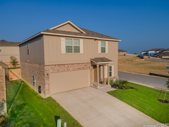 view of front facade featuring a garage and a front yard