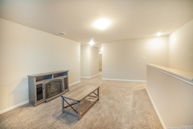 living room with light carpet and a fireplace