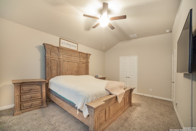 bedroom with carpet, ceiling fan, a closet, and lofted ceiling