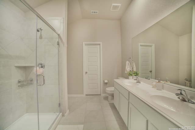 bathroom featuring vaulted ceiling, oversized vanity, toilet, tile floors, and double sink