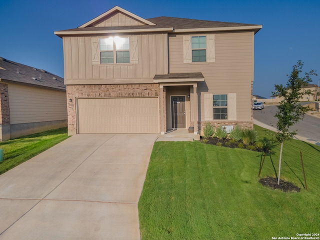 view of front of property with a front lawn and a garage