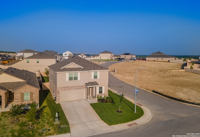 view of property with a garage and a front yard