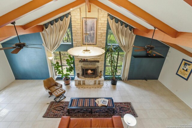 unfurnished living room featuring brick wall, a fireplace, ceiling fan, tile floors, and vaulted ceiling with beams