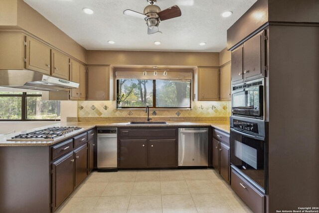 kitchen with ceiling fan, black appliances, backsplash, light tile floors, and sink