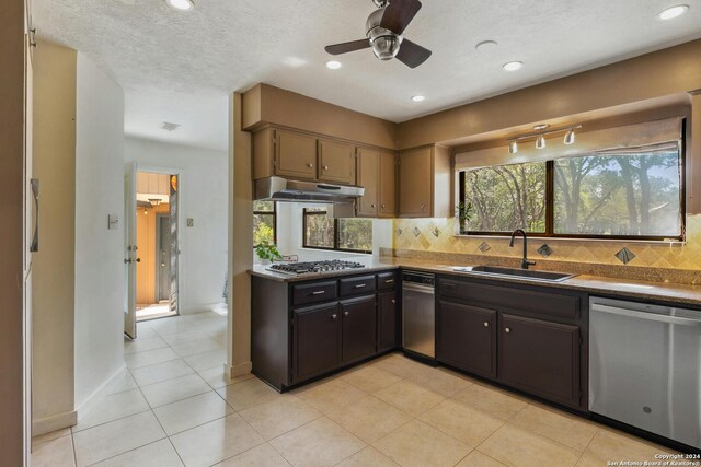 kitchen with ceiling fan, tasteful backsplash, appliances with stainless steel finishes, sink, and light tile floors