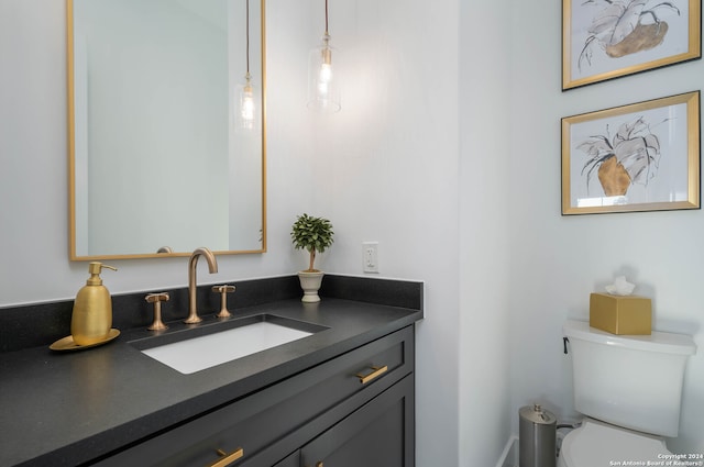 bathroom with vanity with extensive cabinet space and toilet