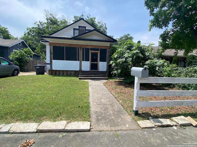 bungalow-style home featuring a front yard