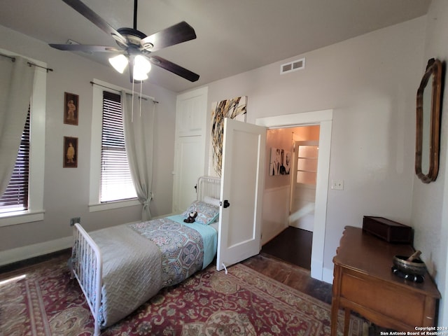 bedroom with dark hardwood / wood-style floors and ceiling fan