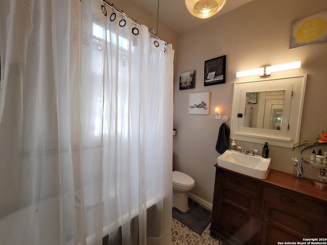 bathroom with tile flooring, vanity, and toilet