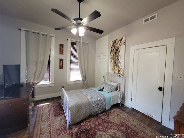 bedroom with ceiling fan and dark hardwood / wood-style floors