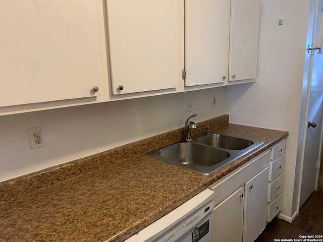 kitchen with white cabinets, dark hardwood / wood-style flooring, and sink