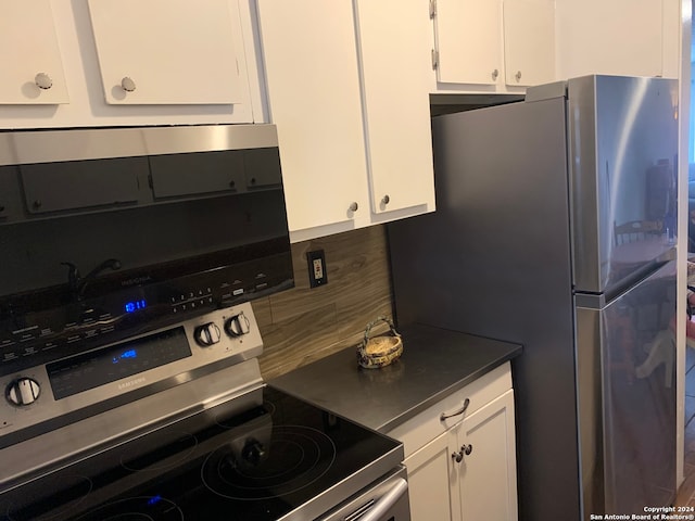 kitchen featuring white cabinets, backsplash, and stainless steel appliances