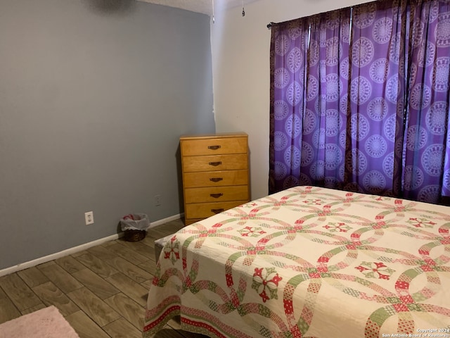 bedroom with hardwood / wood-style flooring