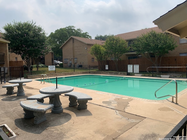 view of swimming pool with a patio area