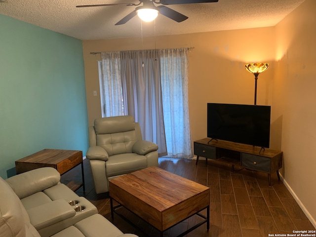 living room with ceiling fan and a textured ceiling