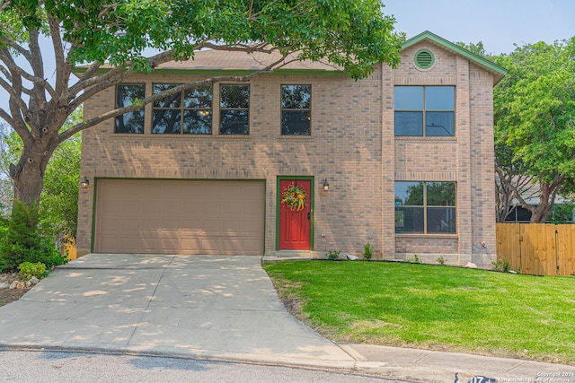 view of front of house with a garage and a front yard