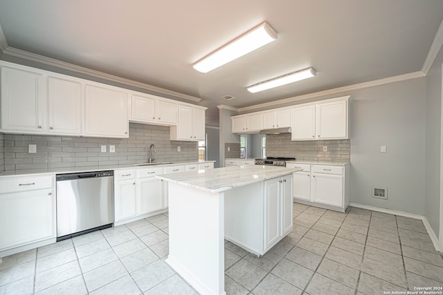 kitchen featuring a center island, sink, decorative backsplash, white cabinets, and appliances with stainless steel finishes