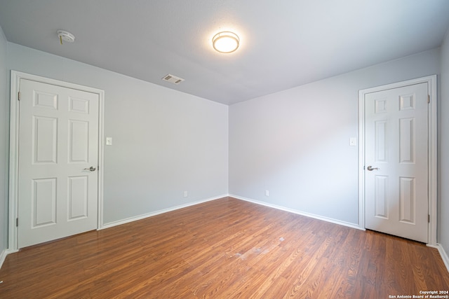 spare room featuring dark hardwood / wood-style floors