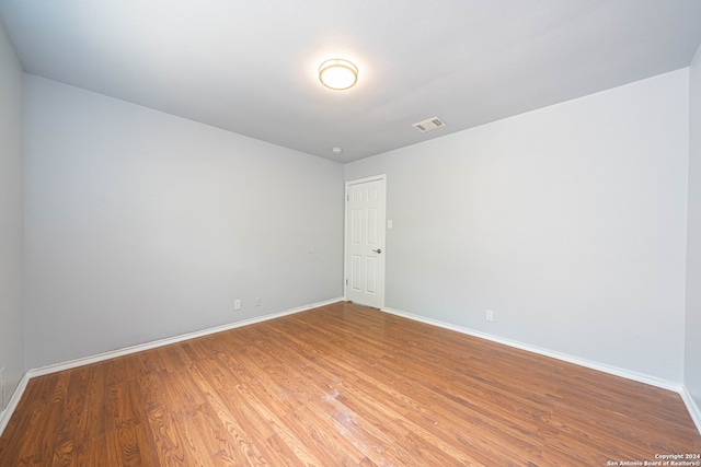 empty room with hardwood / wood-style flooring